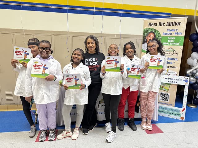 Naomi V. Dunsen-White with young readers holding copies of Johari the Great