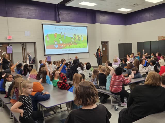 Naomi V. Dunsen-White presenting to a large school audience