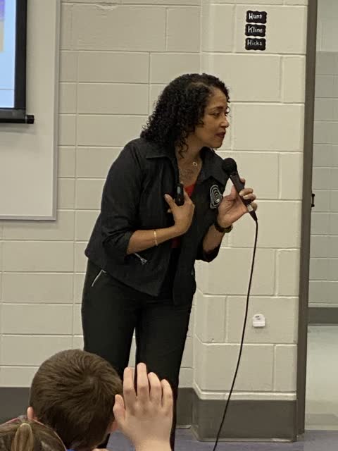 Naomi V. Dunsen-White speaking to students with a microphone
