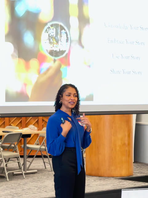 Naomi V. Dunsen-White speaking beneath a presentation about acknowledging and sharing your story